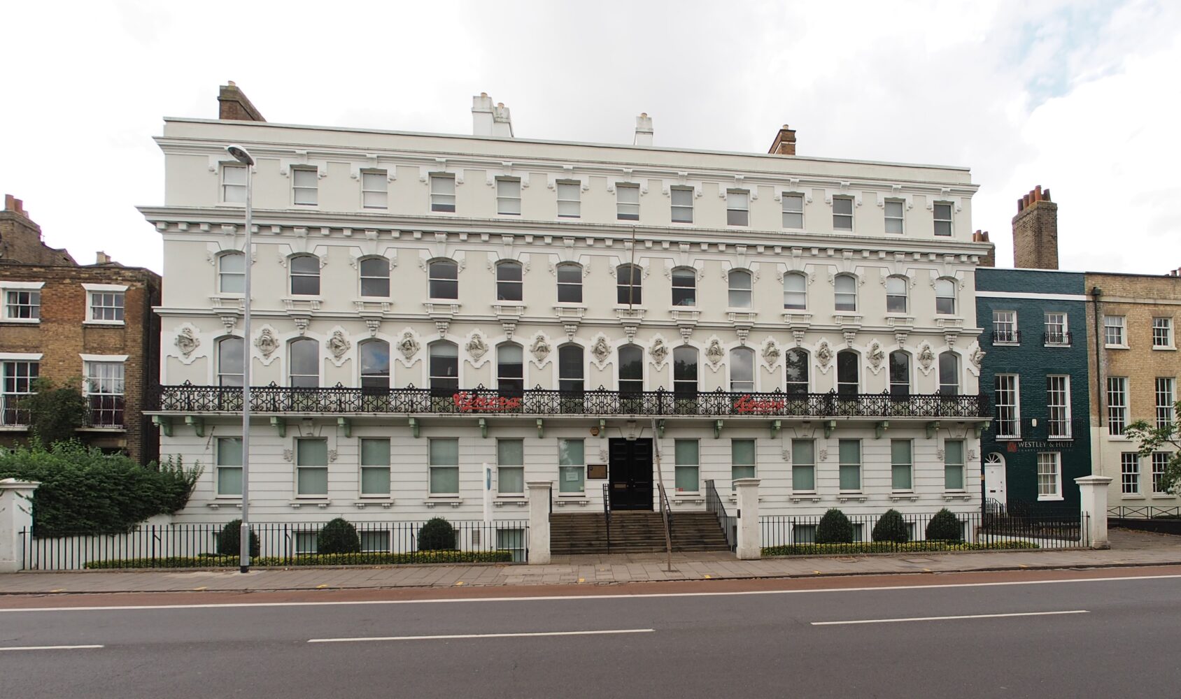 The ornate white Italianate facade of Cintra House on Hills Road, Cambridge, which serves as the regional headquarters of the Open University.