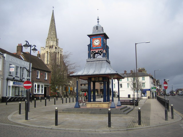 The Clock Tower and Market Cross in Dunstable, Bedfordshire, a Millennium project structure in The Square with the Methodist Church spire visible behind it.